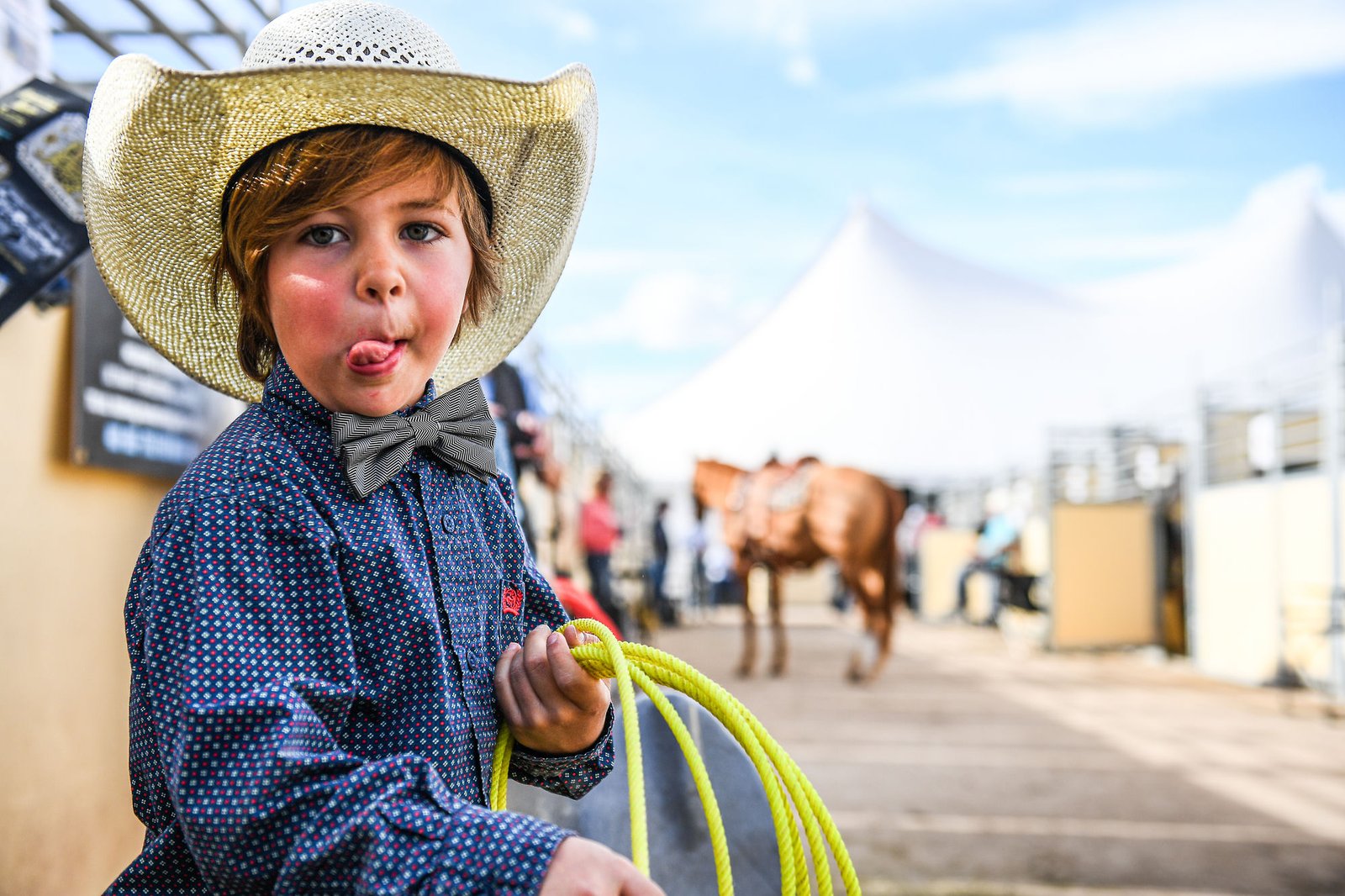 A young ropester in a cowboy hat and bow tie at The Horse Sale at Rancho Rio